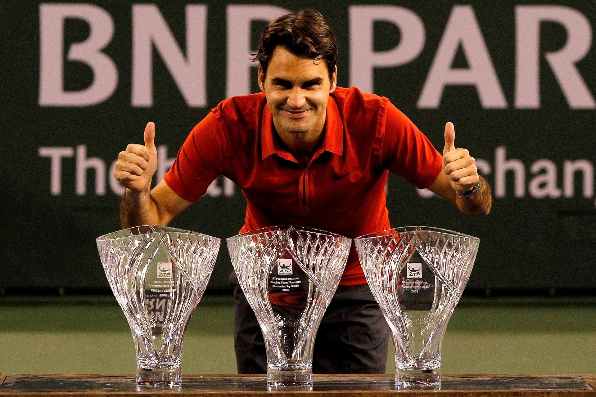 The Swiss maesro poses with ATP Fans' Favorite, Sportsmanship, and POTY awards in 2010 | Image Source: Getty